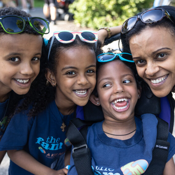 A joyful family smiling together at an A Kid Again adventure event.