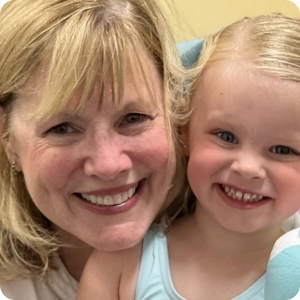 Founder smiling with child. 